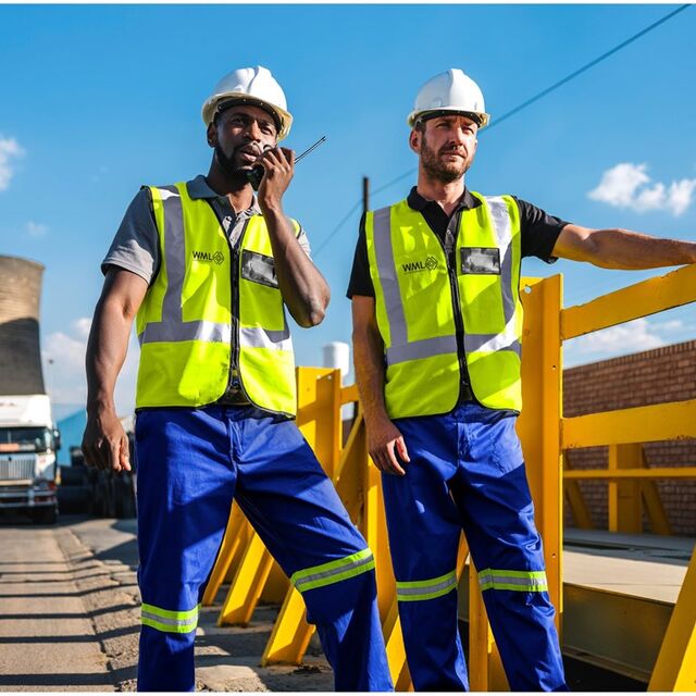 Site workers in hi-visibility vests and hard hats